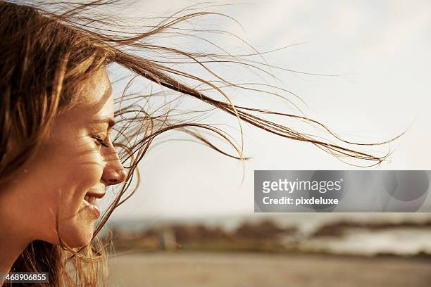 enjoying the fresh sea air - human hair stockfoto's en -beelden