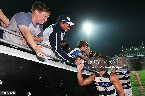 Mathew Stokes and Cameron Guthrie of the Cats celebrate the win during the round one AFL NAB Cup match between the Geelong Cats and the Collingwood...