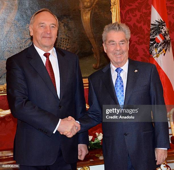 Latvian President Andris Berzins shakes hand with Austrian President Heinz Fischer during his official visit in Vienna, Austria on April 8, 2015.