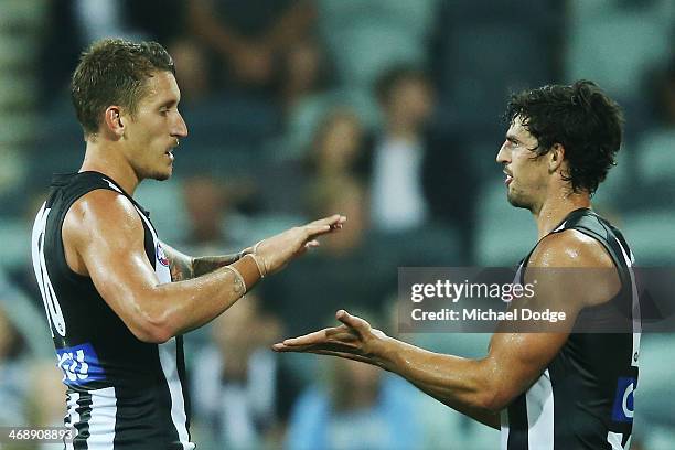 Jesse White of the Magpies celebrates his goal with Scott Pendlebury during the round one AFL NAB Cup match between the Geelong Cats and the...