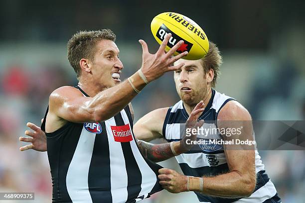 Jesse White of the Magpies marks the ball in front Tom Lonergan of the Cats during the round one AFL NAB Cup match between the Geelong Cats and the...