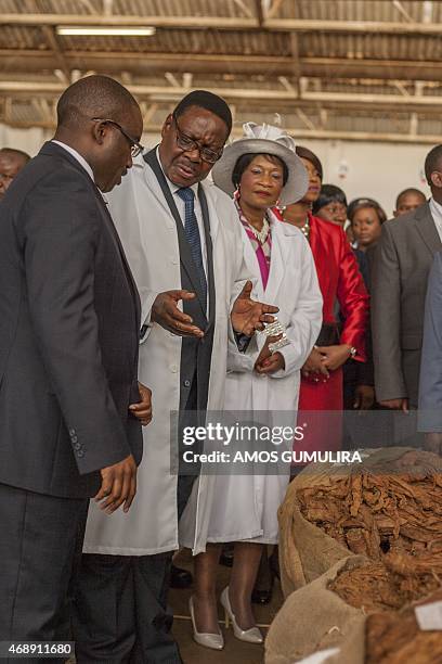 Malawi President Arthur Peter Mutharika talks with Auction Holdings Limited CEO Charles Matabwa next to his wife Gertrude on April 8, 2015 at the...