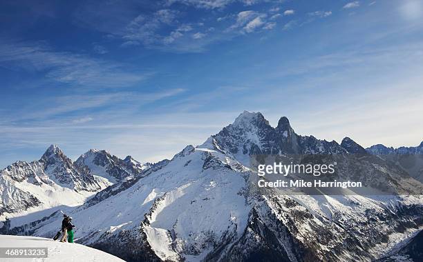 ski and snowboarder looking over mont blanc - haute savoie stockfoto's en -beelden