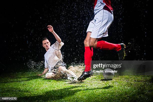 soccer player defending a ball - amateur stock pictures, royalty-free photos & images