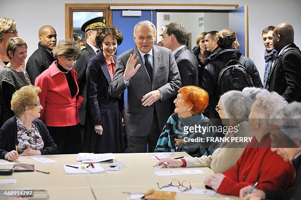 French Prime Minister Jean-Marc Ayrault talks to residents of a retirement home eyed by Health minister Marisol Touraine and Junior minister for...