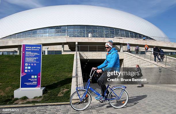 Hockey player Ossi Vaananen of Finland rides a bike outside Bolshoy arena on day five of the Sochi 2014 Winter Olympics at Olympic Park on February...