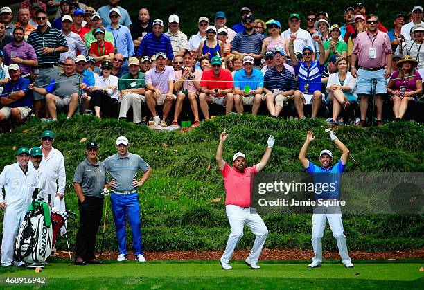 Padraig Harrington and Shane Lowry of Ireland react to a shot during the Par 3 Contest prior to the start of the 2015 Masters Tournament at Augusta...