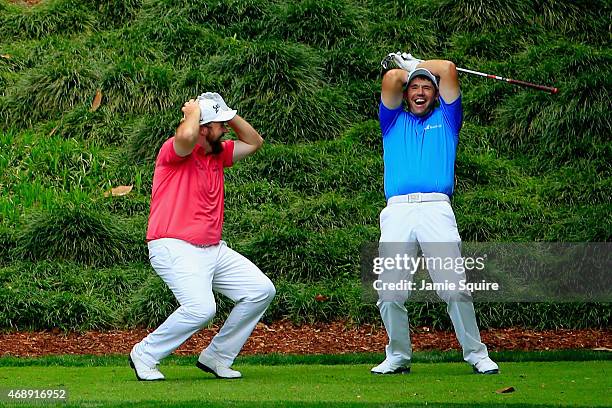 Padraig Harrington and Shane Lowry of Ireland react to a shot during the Par 3 Contest prior to the start of the 2015 Masters Tournament at Augusta...