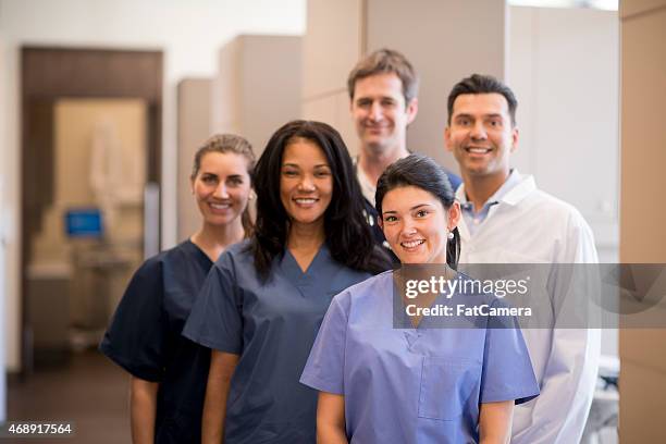 medical setting office - doctor scrubs stockfoto's en -beelden