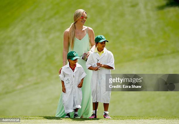 Tiger Woods' girlfriend Lindsey Vonn, son Charlie and daughter Sam watch the play during the Par 3 Contest prior to the start of the 2015 Masters...