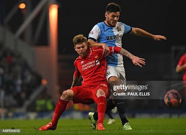 Liverpool's Spanish defender Alberto Moreno vies with Blackburn's English midfielder Ben Marshall during the English FA Cup quarter-final replay...