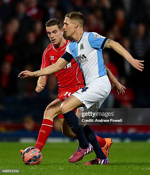 Jordan Henderson of Liverpool competes with Matt Kilgallon of Blackburn Rovers during the FA Cup Quarter Final Replay match between Blackburn Rovers...