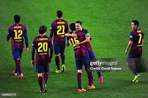 Marc Bartra of FC Barcelona celebrates with his teammate Xavi Hernandez of FC Barcelona after scoring his team's third goal during the La Liga match...