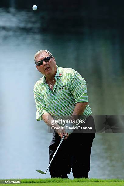 Fuzzy Zoeller of the United States plays a shot during the Par 3 Contest prior to the start of the 2015 Masters Tournament at Augusta National Golf...