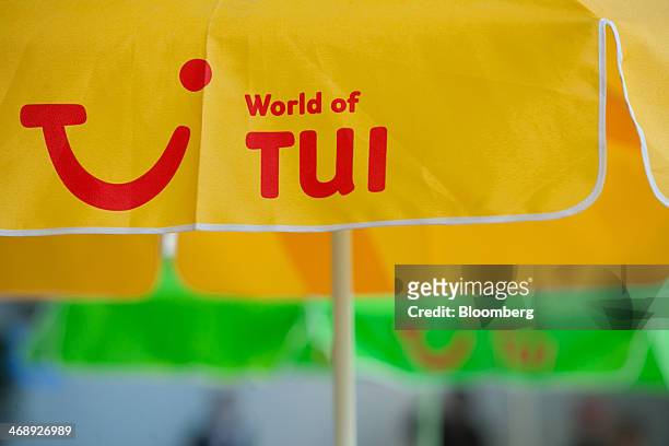 The company logo sits on a sun parasol before TUI AG announces their full-year earnings in Hanover, Germany, on Wednesday, Feb. 12, 2014. TUI AG, the...