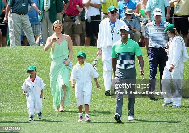 Tiger Woods of the United States walks with his girlfriend Lindsey Vonn, son Charlie and daughter Sam and friend Steve Stricker during the Par 3...