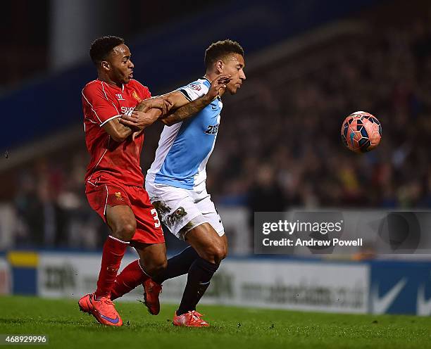 Raheem Sterling of Liverpool competes with Adam Henley of Blackburn Rovers during the FA Cup Quarter Final Replay match between Blackburn Rovers and...