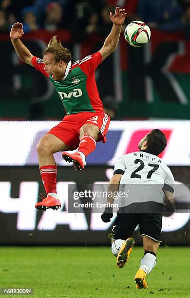 Vitaliy Denisov of FC Lokomotiv Moscow challenged by Hugo Vieira of Torpedo Moscow during the Russian Premier League match between FC Lokomotiv...