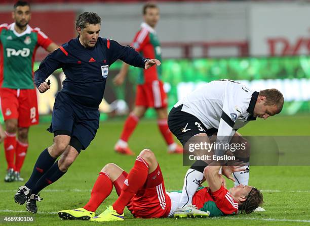 Dmitri Tarasov of FC Lokomotiv Moscow challenged by Vladimir Rykov of Torpedo Moscow during the Russian Premier League match between FC Lokomotiv...