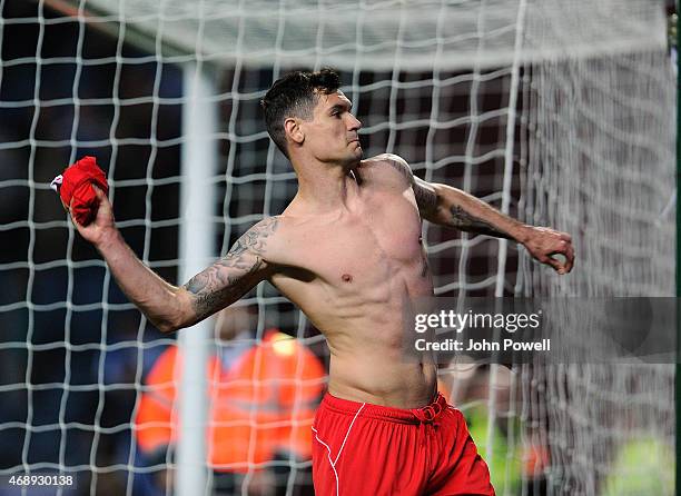 Dejan Lovren of Liverpool throws his shirt into the crowd at the end of the FA Cup Quarter Final Replay match between Blackburn Rovers and Liverpool...