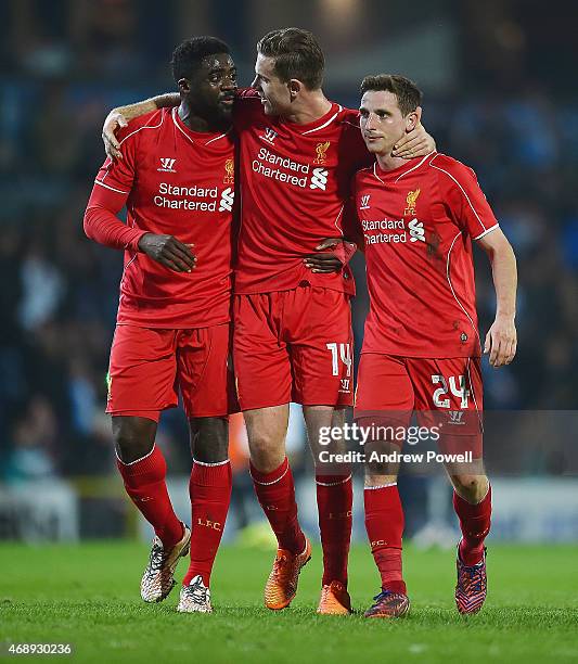 Kolo Toure, Jordan Henderson and Joe Allen of Liverpool celebrate at the end of the FA Cup Quarter Final Replay match between Blackburn Rovers and...