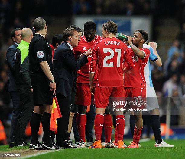 Brendan Rodgers manager talks with Kolo Toure, Lucas Leiva and Raheem Sterling of Liverpool celebrate at the end of the FA Cup Quarter Final Replay...