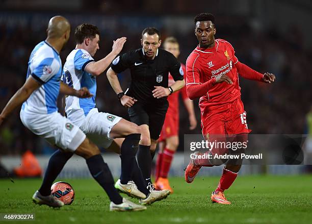 Daniel Sturridge of Liverpool competes with Corry Evans of Blackburn Rovers during the FA Cup Quarter Final Replay match between Blackburn Rovers and...