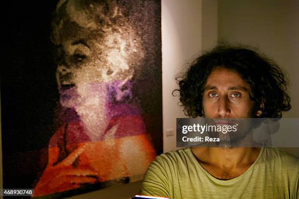 October 6 ALAN stanbul, Beyoglu, Istanbul, Turkey. A portrait of the Turkish artist, Murat Pulat standing next to one of his paintings of Marilyn...