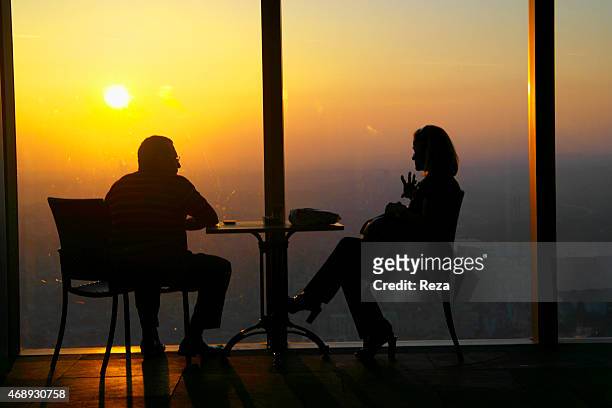 October 6 Isbank Tower 1, Levent District, Istanbul, Turkey. A couple watches the sunset from a cafe in the Isbank Tower 1, located near the Kanyon...