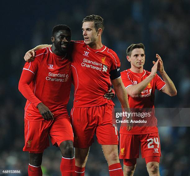 Players Kolo Toure , Jordan Henderson and Joe Allen of Liverpool celebrate after winning the FA Cup Quarter Final Replay match between Blackburn...