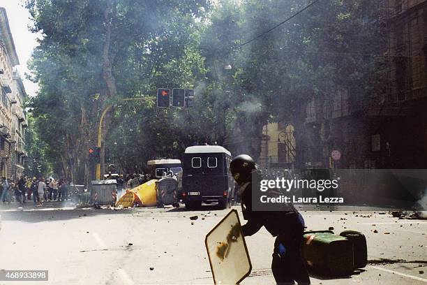 An anti-G8 protester clashes with police on the first day of the G8 Summit on July 20, 2001 in Genoa, Italy. Thousands of anti G8 protesters from all...