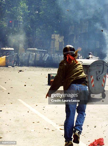 An anti-G8 protester throws stones against the Carabinieri police on the first day of the G8 Summit on July 20, 2001 in Genoa, Italy. Thousands of...