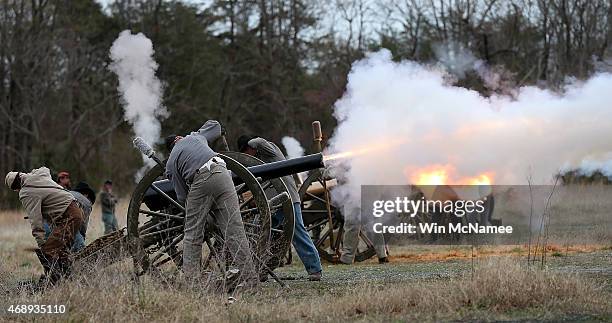 American Civil War re-enactors dressed as Confederate artillery teams fire their cannons at a re-enactment of the Battle of Appomattox Station April...