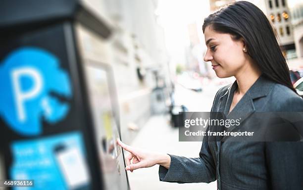 business woman paying th parking at the machine - happiness meter stock pictures, royalty-free photos & images