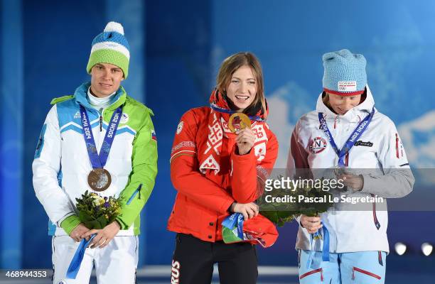 Silver medalist Tora Berger of Norway, gold medalist Darya Domracheva of Belarus and bronze medalist Teja Gregorin of Slovenia celebrate on the...