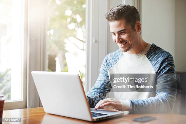 man using laptop at table. - only men stock pictures, royalty-free photos & images