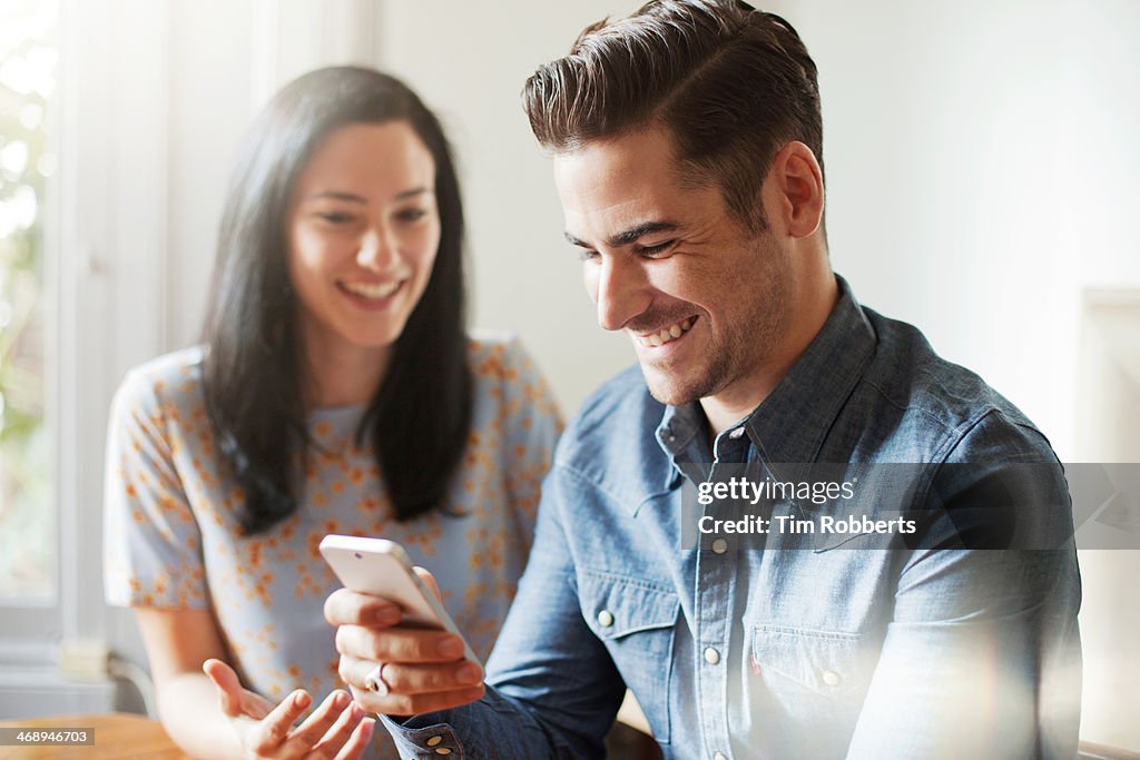 Man smiling with smart phone.