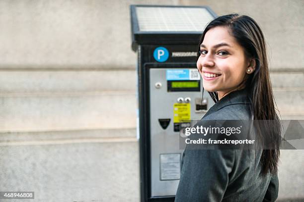 business woman paying th parking at the machine - happiness meter stock pictures, royalty-free photos & images