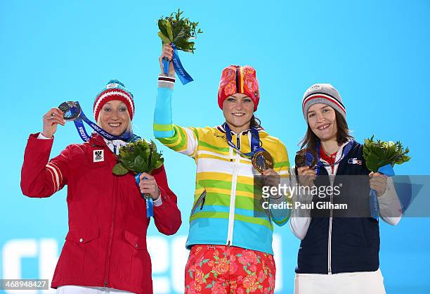 Silver medalist Daniela Iraschko-Stolz of Austria, gold medalist Carina Vogt of Germany and bronze medalist Coline Mattel of France celebrate on the...