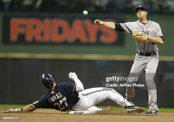 Lemahieu of the Colorado Rockies forces out Carlos Gomez of the Milwaukee Brewers at second base and throws on to first for a double play in the...