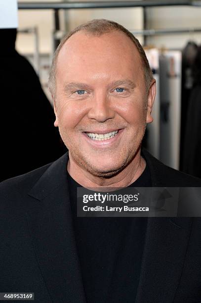 Designer Michael Kors prepares backstage at the Michael Kors fashion show during Mercedes-Benz Fashion Week Fall 2014 at Spring Studios on February...