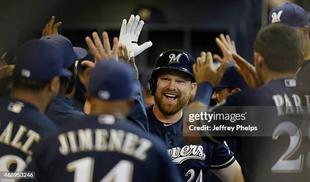 Adam Lind of the Milwaukee Brewers reacts with teammates after his two run home run against the Colorado Rockies in the third inning at Miller Park...