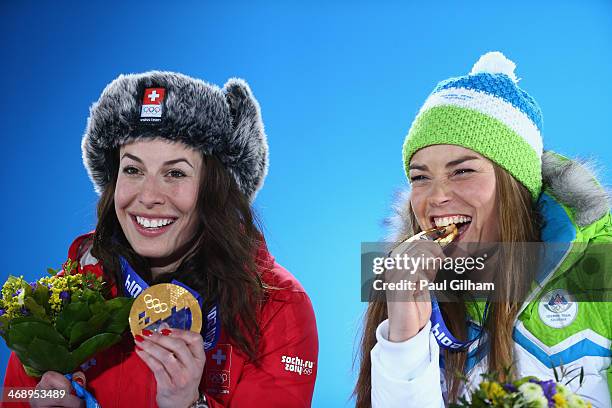 Joint gold medalists Dominique Gisin of Switzerland and Tina Maze of Slovenia celebrate during the medal ceremony for the for the Alpine Skiing...