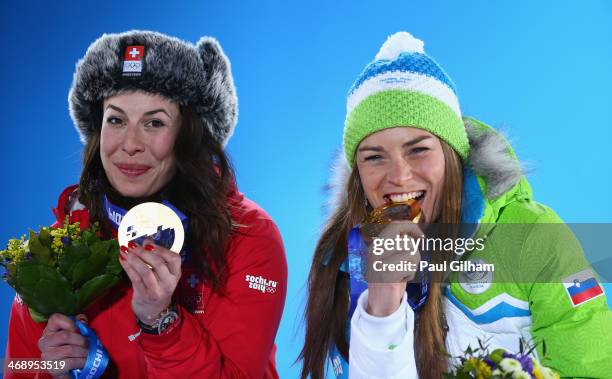 Joint gold medalists Dominique Gisin of Switzerland and Tina Maze of Slovenia celebrate during the medal ceremony for the for the Alpine Skiing...