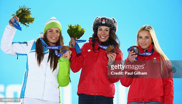 Joint gold medalists Tina Maze of Slovenia and Dominique Gisin of Switzerland and bronze medalist Lara Gut of Switzerland celebrate during the medal...