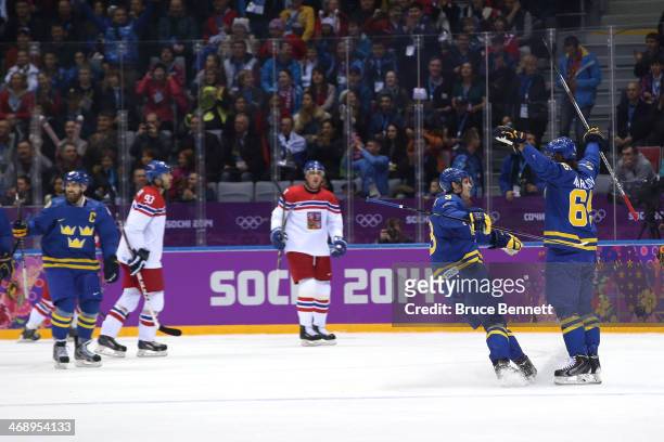 Erik Karlsson of Sweden celebrates with teammate Oliver Ekman Larsson after scoring a goal in the first period against Jakub Kovar of Czech Republic...