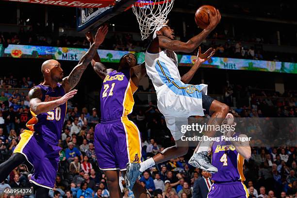 Will Barton of the Denver Nuggets lays up a shot against Robert Sacre, Ed Davis and Ryan Kelly of the Los Angeles Lakers at Pepsi Center on April 8,...