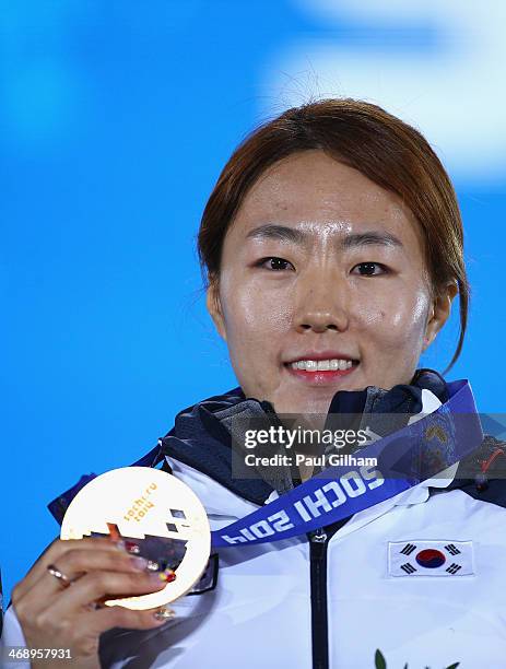 Gold medalist Sang Hwa Lee of South Korea celebrates during the medal ceremony for the Women's 500m on day five of the Sochi 2014 Winter Olympics at...