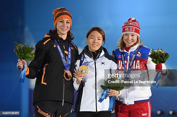 Bronze medalist Margot Boer of the Netherlands, gold medalist Sang Hwa Lee of South Korea and silver medalist Olga Fatkulina of Russia celebrate on...