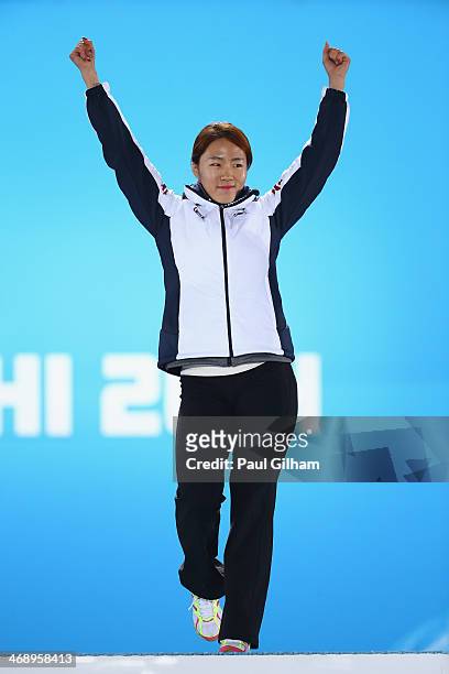 Gold medalist Sang Hwa Lee of South Korea celebrates during the medal ceremony for the Women's 500m on day five of the Sochi 2014 Winter Olympics at...